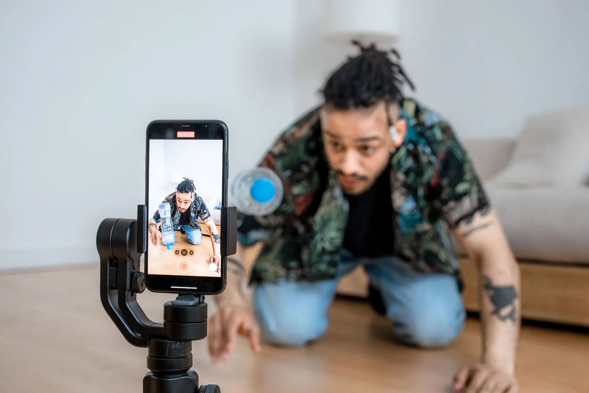 Creator filming himself with an iPhone on a tripod